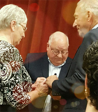Photo of Dianne and Bob exchanging rings