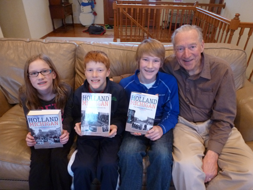 Photo of Robert Swierenga with his grandchildren holding the books